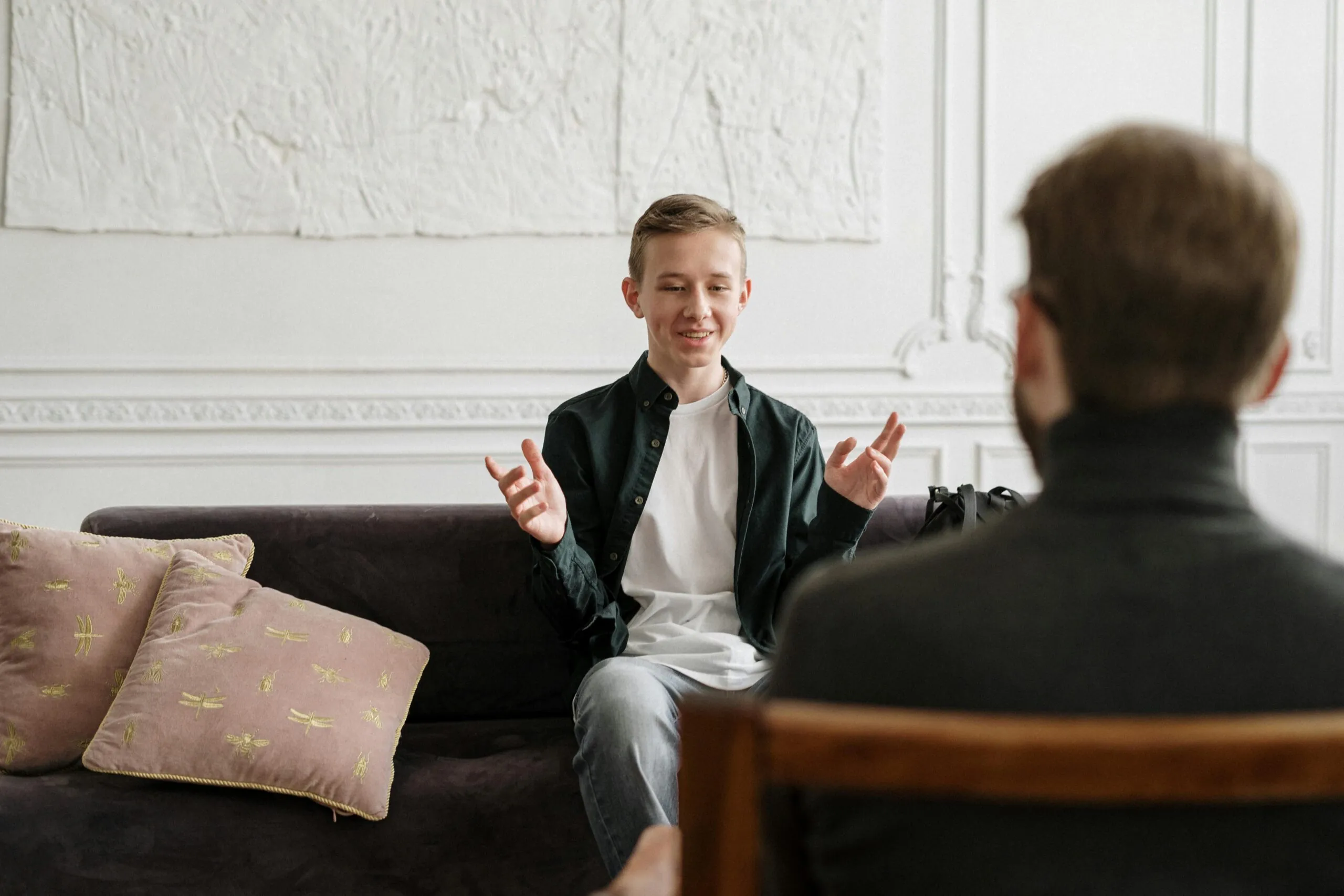Jovem conversa com um profissional numa consulta presencial